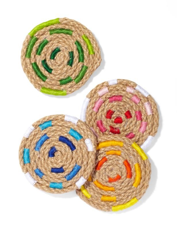 three coasters made out of rope with colorful circles on them