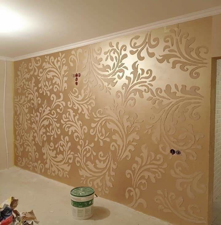 the wall is being painted with gold paint