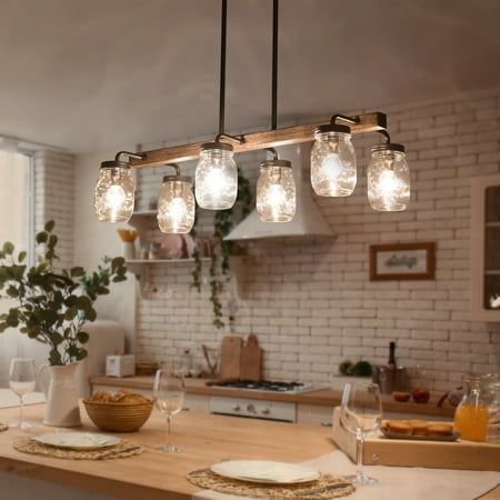 a kitchen island with lights hanging over it