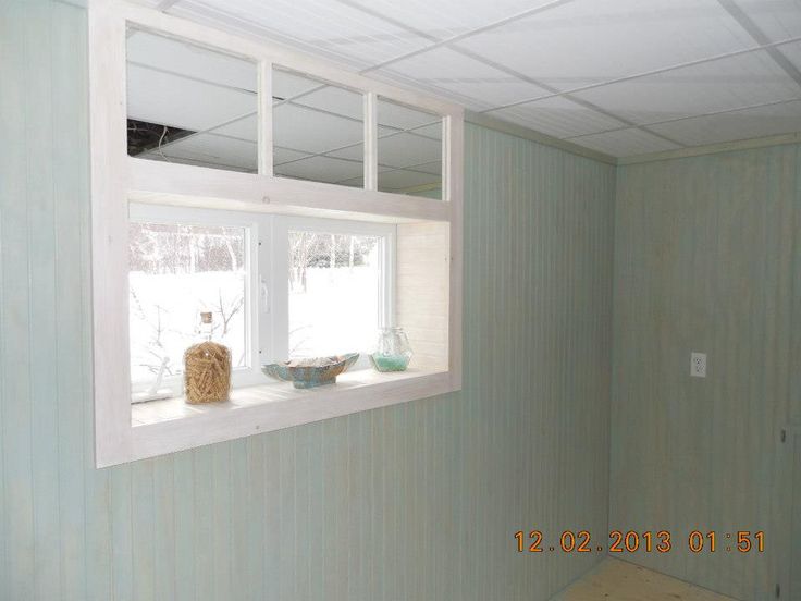 an empty room with two windows and no curtains on the wall, in front of a window sill