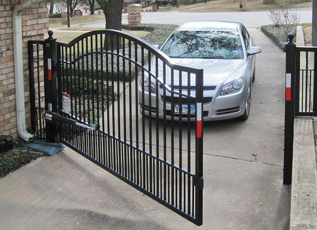 a car parked in front of a driveway gate