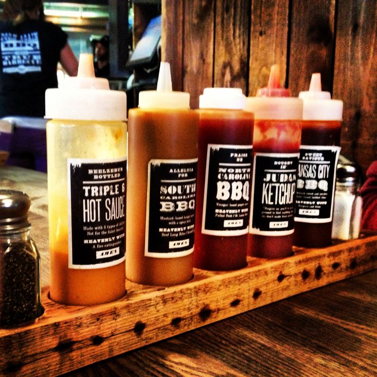 several different types of condiments on a wooden tray