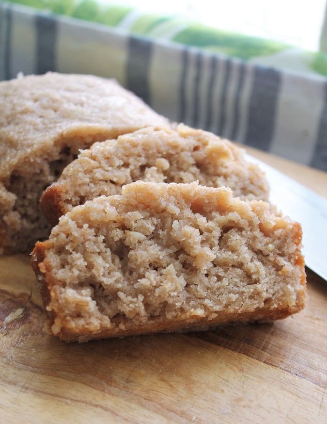 two pieces of bread sitting on top of a wooden cutting board