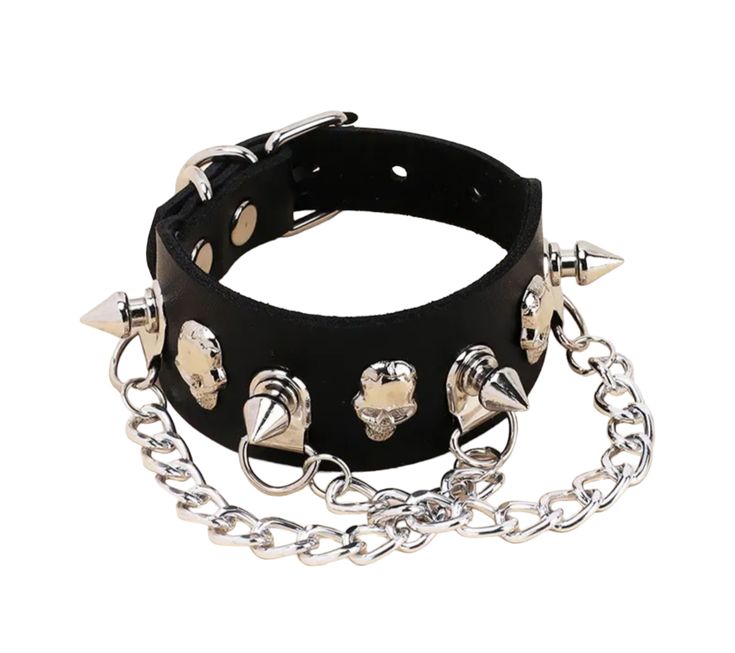 "Chained Up": Show off your gothic flair with this sassy Chained Up Black Leather Choker and Bracelet Set! Constructed from sleek black leather, the set features shiny chains and rings for a sultry yet edgy look. The adjustable choker and bracelet make it easy to show off your unique style. The bracelet is adorned with spikes and skulls. Ready to take the world by storm? It's time to get 'chained up'!😉 Necklace measures approximately 17" and is adjustable. Bracelet measures approximately 9.5 an Gothic Leather Jewelry For Party, Black Leather Punk Jewelry, Punk Black Jewelry With Chain Strap, Black Punk Jewelry With Chain Strap, Black Rock Style Jewelry For Halloween, Punk Leather Jewelry For Concerts, Black Edgy Jewelry With Chain Strap, Gothic Jewelry For Biker Events And Halloween, Black Rocker Style Metal Jewelry