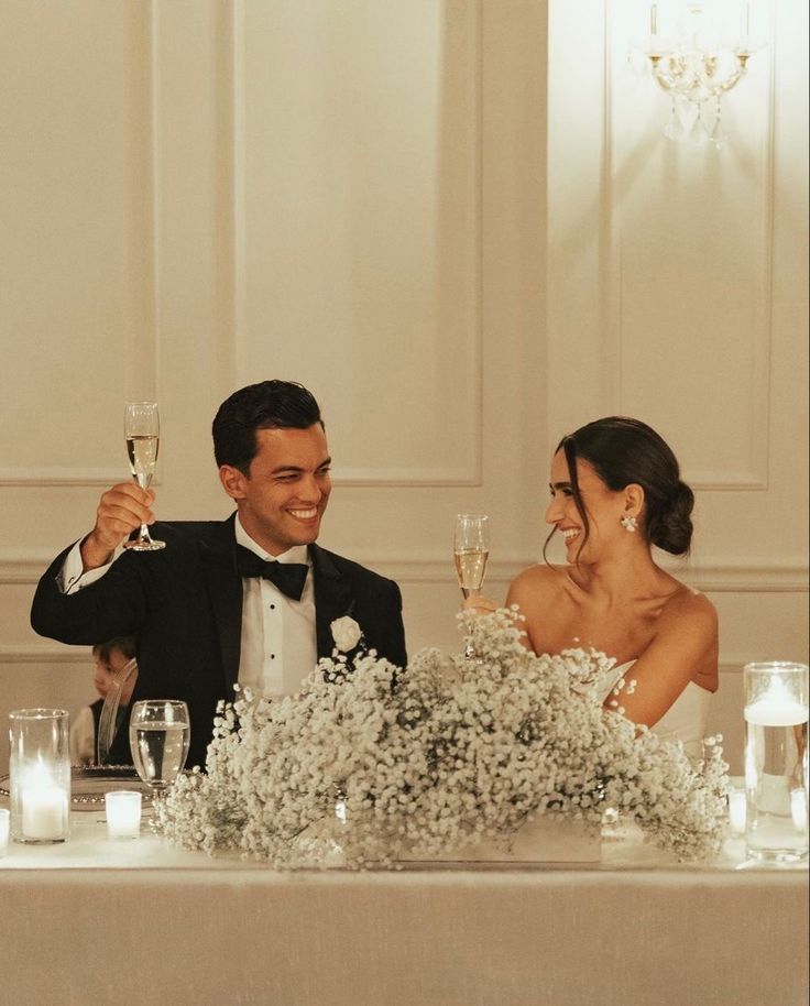 a bride and groom toast at their wedding reception