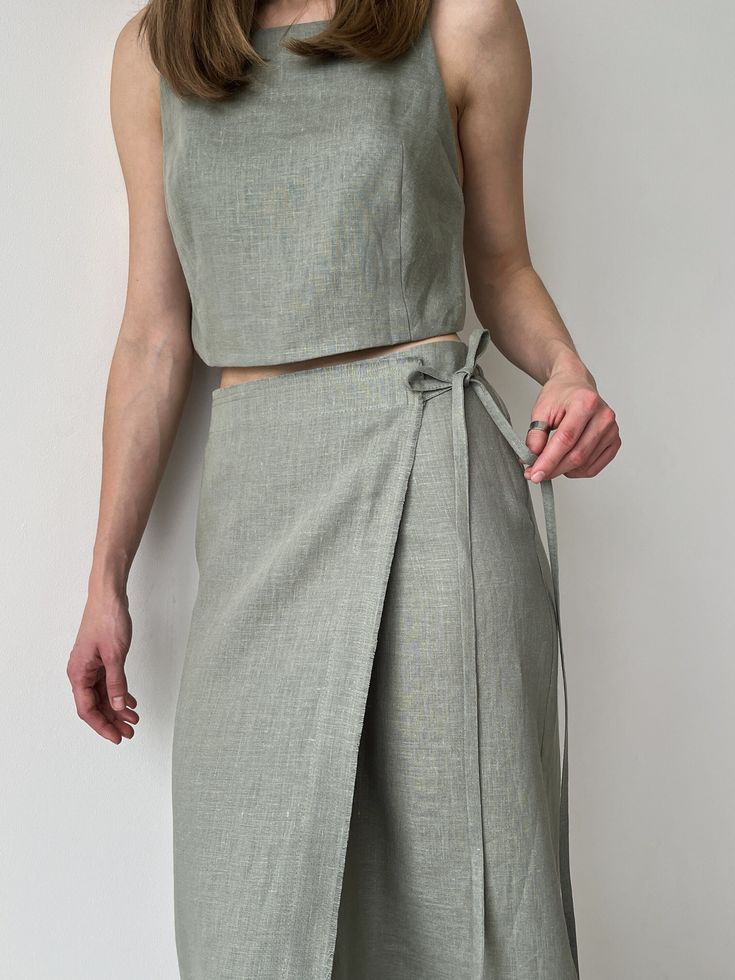 Linen wrap skirt for women, Green linen skirt with slit, High rise pencil skirt, Wrapped skirt, Long straight skirt, Midi belted skirt This handmade skirt is a must-have for your summer, perfect for a day of meetings or outdoor activities. Linen makes the best micro-climate of the skin, is breathable, and absorbs moisture and perspiration. ■ check out our crop top for a matching outfit: https://www.etsy.com/listing/1482624794/ ■ color: green available in: yellow https://www.etsy.com/listing/1272115716/ black https://www.etsy.com/listing/1505549041 beige https://www.etsy.com/listing/1254313035/ ■ material: 100% linen ■ style: - wrap skirt - relaxed fit - mid-calf length - high waist - textile belt -raw edge ■ fit: The model is 168cm/ 5′ 6″ tall and wears a size XS ■ how to care: - Hand wash Casual Summer Wrap Skirt, Wrap Skirt Corset, Luxury Linen Skirt For Work, Luxury Relaxed Fit Skirt For Summer, Luxury Linen Midi Skirt, Chic Luxury Wrap Skirt, Luxury Fitted Linen Skirt, Luxury Summer Draped Skirt For Women, Sewing Wrap Around Skirt