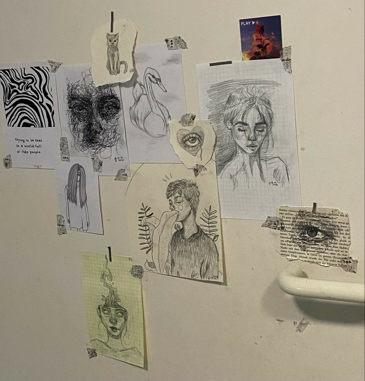 a refrigerator covered in lots of drawings and magnets