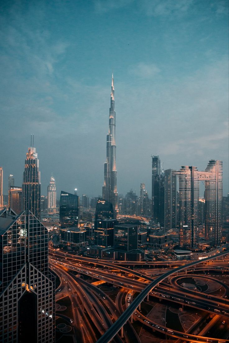 an aerial view of a city with lots of traffic and skyscrapers in the background