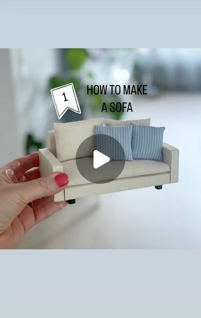 a hand holding a miniature couch with the text how to make a sofa