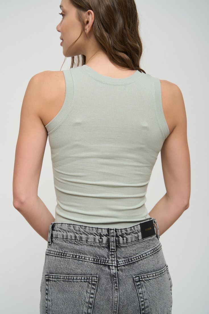 The basic rib-knit tank top is a versatile base for outfits in different styles, including sporty and casual looks. It pairs well with jeans, shorts, joggers, oversized shirts, and denim jackets. Its slim-fit style allows you to look stunning. This item is very comfortable and practical for the summer season, so we recommend buying it several in different colors. Solid Ribbed Tops With Tank Straps, Solid Ribbed Tank Straps Tops, Trendy Seamless Tank Top For Summer, Trendy Seamless Summer Tank Top, Fitted Casual Tank Top For Streetwear, Basic Cotton Tank Top For Summer, Fitted Basic Tank Top For Summer, Casual Solid Seamless Tank Top, Casual Seamless Solid Tank Top