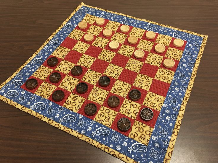 a close up of a board game on a table with buttons and cloth around it