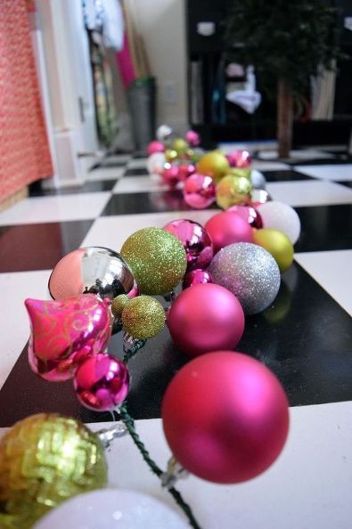 a black and white checkered floor with pink, yellow and silver ornaments on it