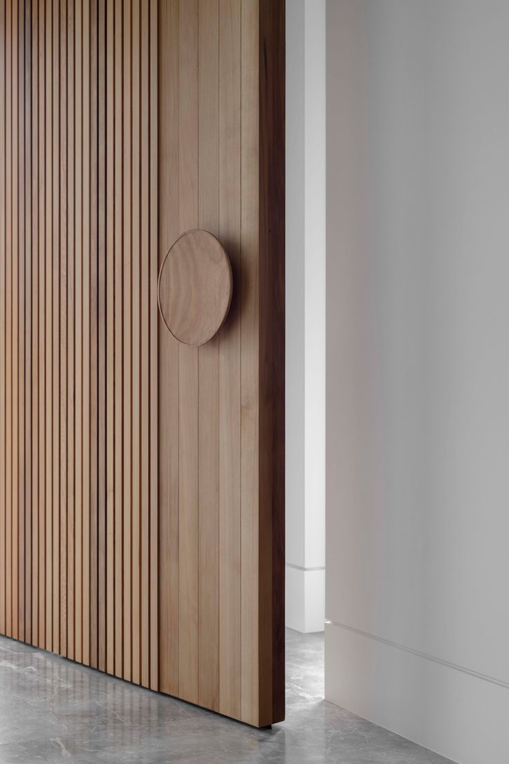 a wooden door with a round knob on it's side in an empty room