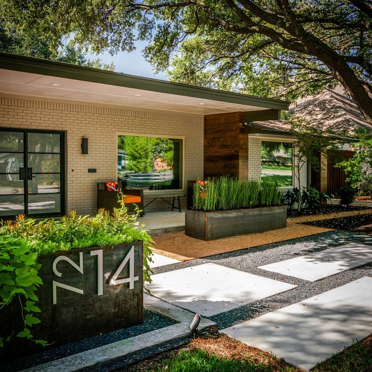 a house with plants in the front yard and number 414 on the outside wall