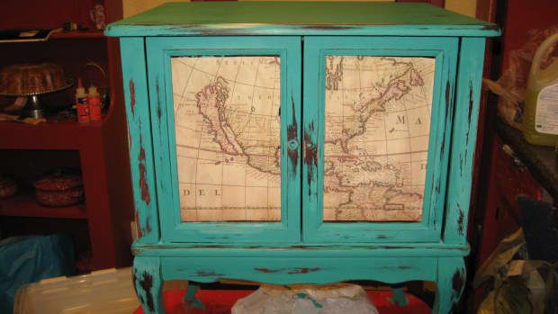 an old blue cabinet with a map on it