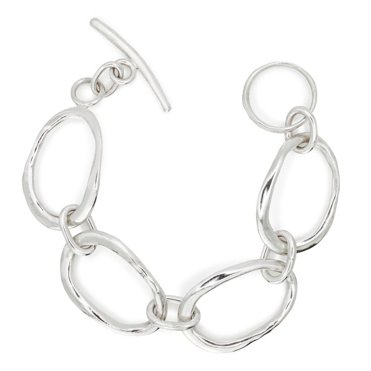 Crafted with a unique design inspired by the fluidity of the ocean. Each link resembles liquid ovals delicately intertwined, creating a mesmerizing visual reminiscent of the ebb and flow of waves. Secured with a toggle and ring clasp, this bracelet not only offers a secure closure but also adds a touch of sophistication to the overall aesthetic. Every detail is meticulously crafted by hand in solid sterling silver, ensuring a one-of-a-kind piece that exudes artistry and elegance. Embrace the essence of the sea with this captivating bracelet, whether you're adding a subtle hint of coastal charm to your everyday look or seeking a statement accessory for a special occasion. Let the beauty of the ocean grace your wrist with this exquisite piece of jewelry. DETAILS Hand cast in sterling silver. Adjustable Oval Link Bracelet With Polished Finish, Modern Sterling Silver Bracelet, Modern Wavy Silver Jewelry, Elegant Sterling Silver Link Bracelet With Oyster Style, Contemporary Adjustable Oyster Bracelet Jewelry, Modern Oval Link Chain Bracelet With Polished Finish, Elegant Wavy Silver Jewelry, Modern Sterling Silver Bracelet With Polished Oval Link, Elegant Sterling Silver Adjustable Oval Link Bracelet