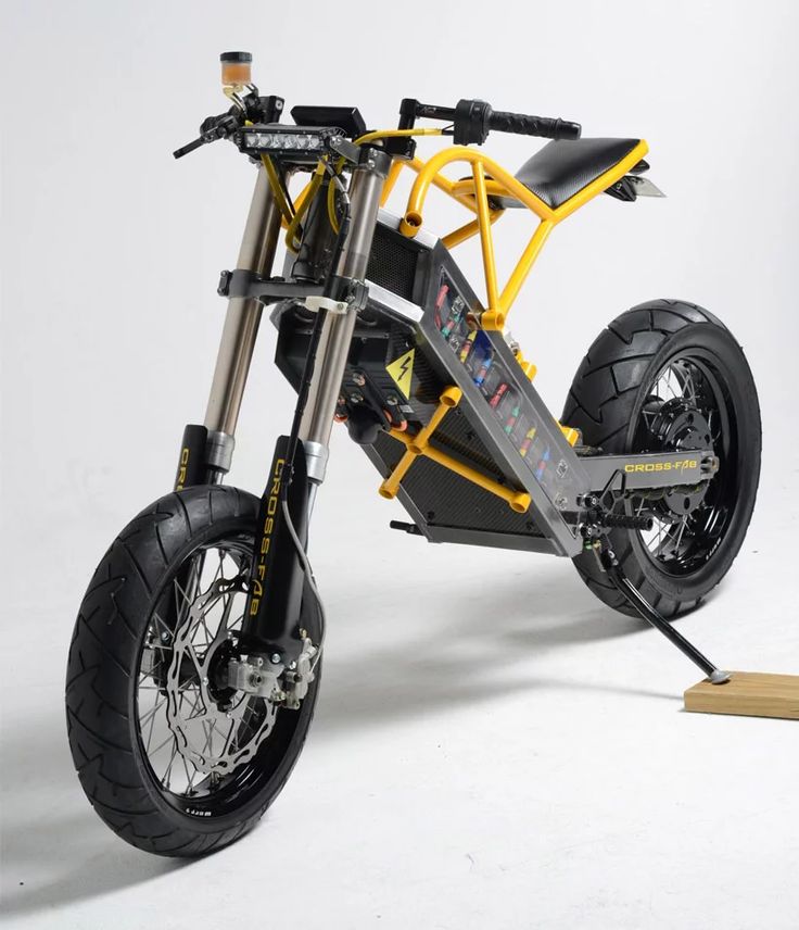 a yellow and black motor bike on a white background