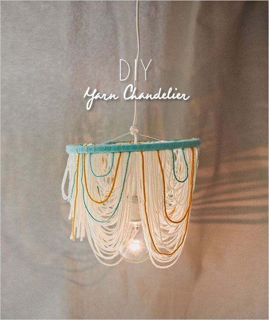 a chandelier hanging from the ceiling with words above it that reads, diy yarn chandelier