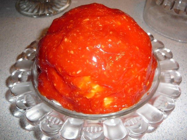 an orange cake sitting on top of a glass plate