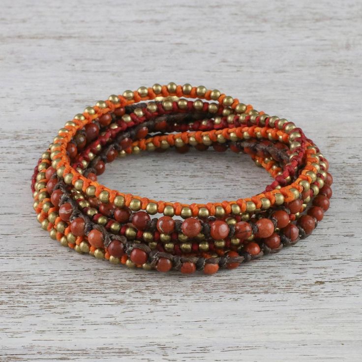 For a festive and delightfully bohemian addition to your wardrobe this wrap bracelet is designed and crafted by Thai artisan Tiraphan Hasub. She hand-braids red orange and brown lengths of polyester cord beaded with red jasper and gleaming brass. The wrap bracelet closes with an adjustable button clasp accentuated by ringing brass bells. Wristband Bracelet, Beaded Wrap Bracelets, Brass Bracelet, Brass Bells, Popular Jewelry, Beaded Wraps, Beaded Anklets, Bracelet Boho, Green Quartz