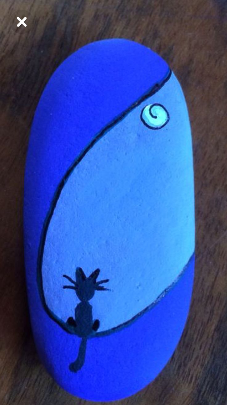 a painted rock with a lizard on it