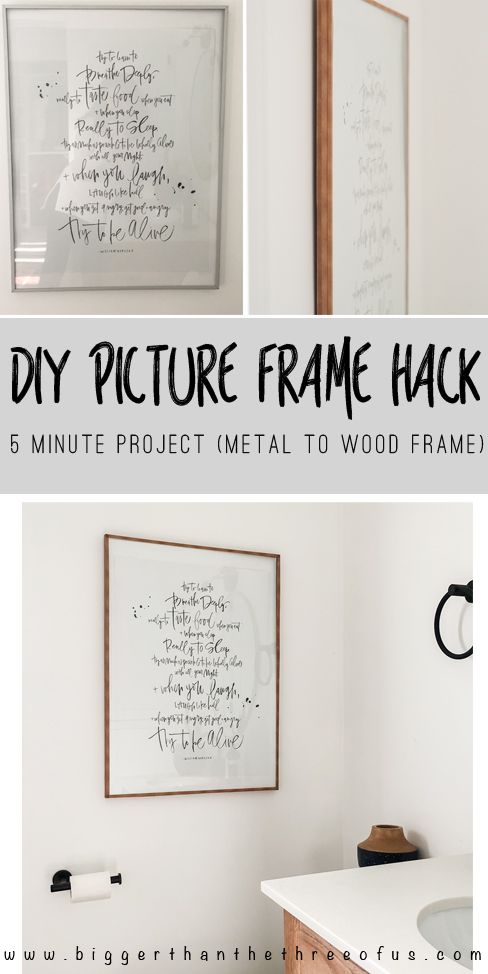 the frame is hanging on the wall next to a desk with a laptop and other items