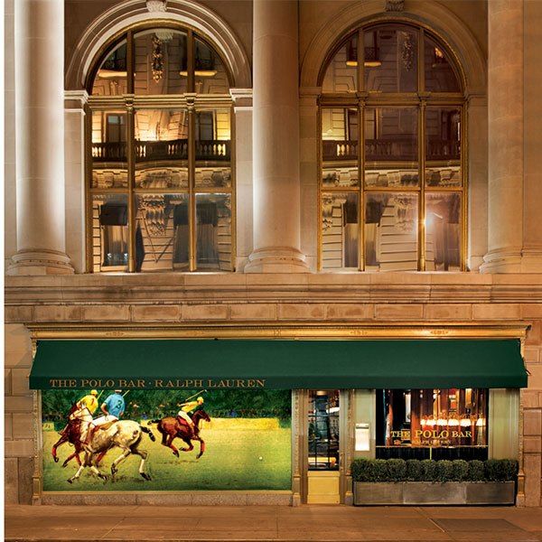 a store front with two horses running in the grass on it's display window