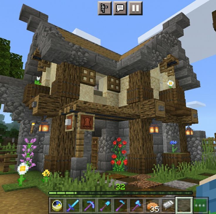 an image of a house in minecraft with flowers on the front and side windows