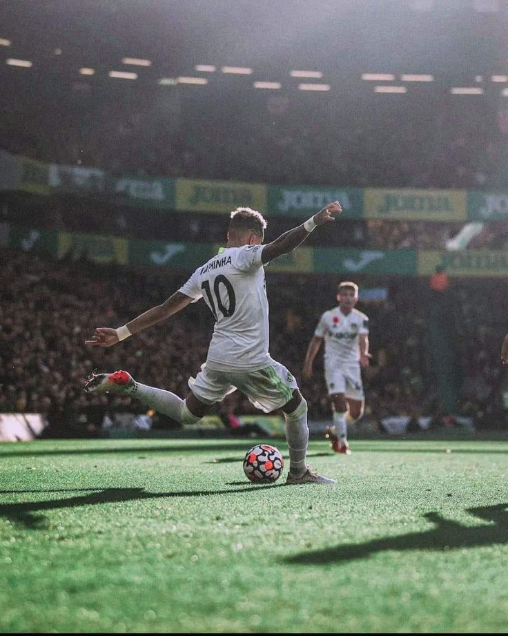 two soccer players are playing on the field