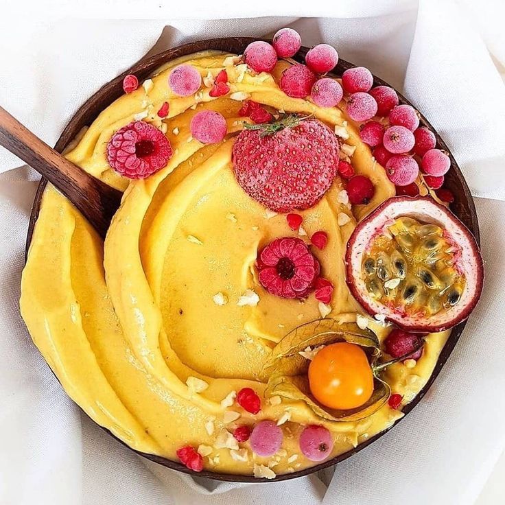 a bowl filled with different types of food on top of a white cloth covered table