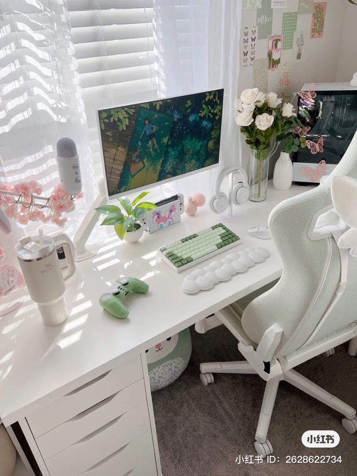 a white desk with a computer, keyboard and flowers in vases on the table