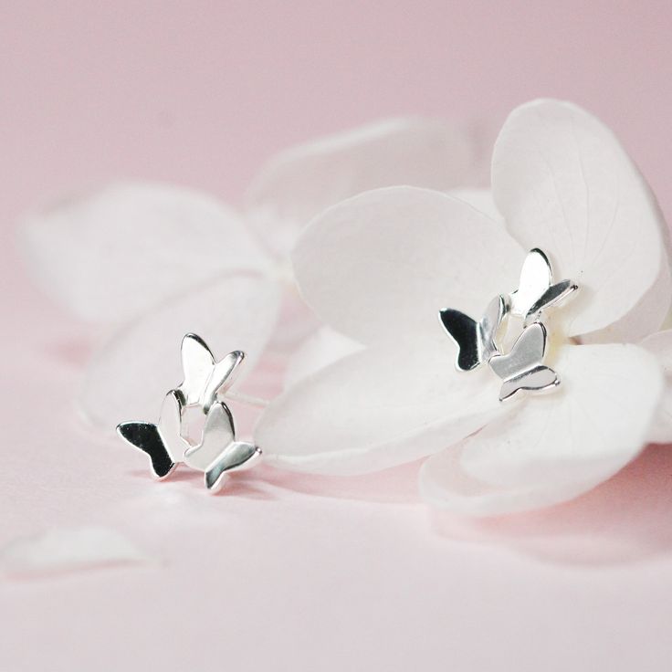 A pair of cute dainty minimalist stud earrings features three tiny butterflies, made of authentic 925 sterling silver highly polish for a great shine. Elegant and delicate, these tiny butterfly stud earrings are a perfect addition to any jewelry collection. Crafted with authenticity in mind, they are made of 925 sterling silver and boast a high polish for a stunning shine. Wear them comfortably every day, and let the subtle yet charming butterfly design add a touch of whimsy to your outfit. Materials: 925 sterling silverDimensions: 0.33 x 0.33 in Jewelry Care: See more information about how to care for your jewelry here. Shipping Policy: Orders will be shipped within 1-3 business days. Economy shipping will take 7-14 days to arrive and standard shipping is 1- 4 days for U.S. orders. Intern Minimalist Sterling Silver Butterfly Earrings, Tiny Butterfly, Minimalist Stud Earrings, Butterfly Stud Earrings, Minimalist Earrings Studs, Butterfly Earrings Stud, Minimalist Studs, Animal Earrings, For Your Love