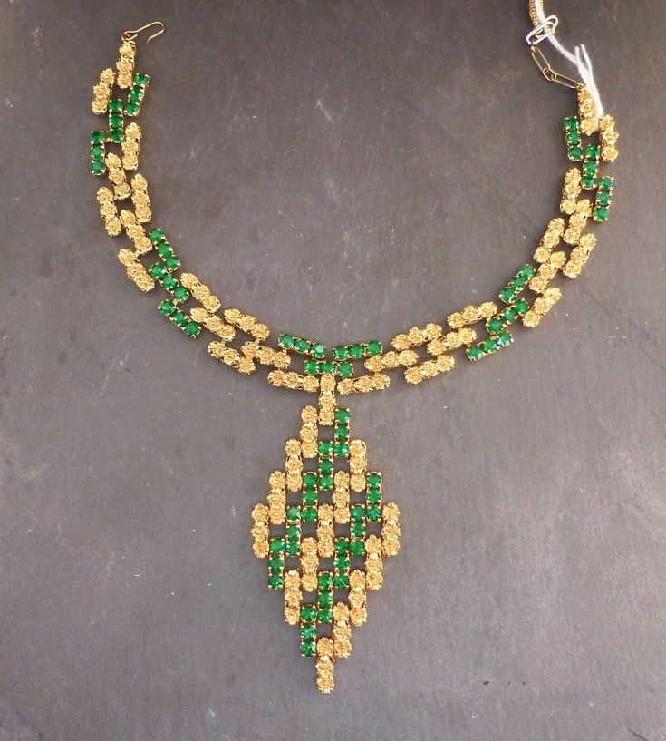 Item oxfj8 Price £125 Circa 1960 Wow this is an absolutely fabuuuuuulous necklace. This piece has a bold profile with vibrant emerald green stones and gold tone flowers, in a link design that moves and adjusts to your neckline when worn. The necklace has a substantial weight and feel and lies flush along your neckline when worn. Overall this is a well made and uniquely designed necklace. The diamond pendant measures approx. 8.5x4.5cm, the necklace measures 31cm extending to 35cm, 1.5cm wide. Green Jeweled Necklaces For Anniversary, Green Jeweled Necklace For Anniversary, Formal Green Emerald Necklace With Jewels, Vintage Emerald Necklace With 17 Jewels As A Gift, Vintage Gold Emerald Necklace For Formal Occasions, Green Emerald Pendant Necklace For Formal Occasions, Green Pendant Jewelry For Evening, Formal Green Emerald Pendant Necklace, Vintage Green Evening Jewelry