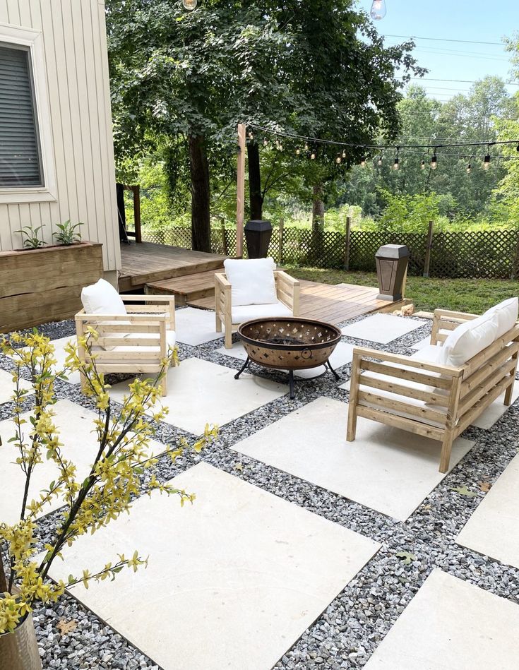 a patio with chairs and a fire pit