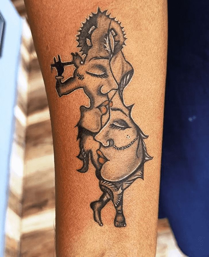 a woman's leg with a tattoo on it that has an image of a man holding