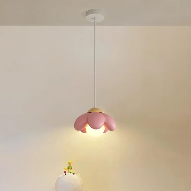 a pink and white lamp hanging from the ceiling