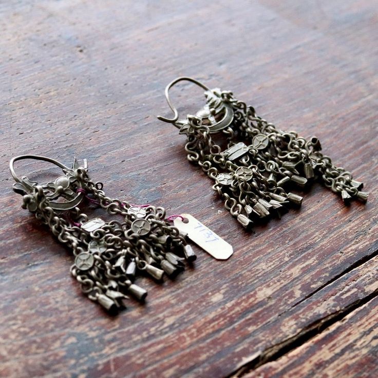 These dangle earrings are antiques that originate from the Qing Dynasty, where a noble woman would have worn an intricate design such as this for a special occasion.Antique stock, made by hand in the late 19th or early 20th century. Length 3 1/2 to 4 1/2 inches. Traditional Earrings With Intricate Design, Elegant Oxidized Earrings For Ceremonial Occasion, Elegant Ceremonial Earrings With Oxidized Finish, Vintage Festival Plug Drop Earrings, Vintage Drop Plug Earrings For Festivals, Vintage Plug Drop Earrings For Festivals, Traditional Silver Dangle Clip-on Earrings, Traditional Dangle Clip-on Earrings For Formal Occasions, Ceremonial Chandbali Metal Earrings