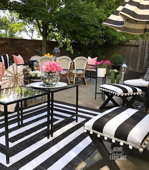 the patio is decorated with black and white striped furniture