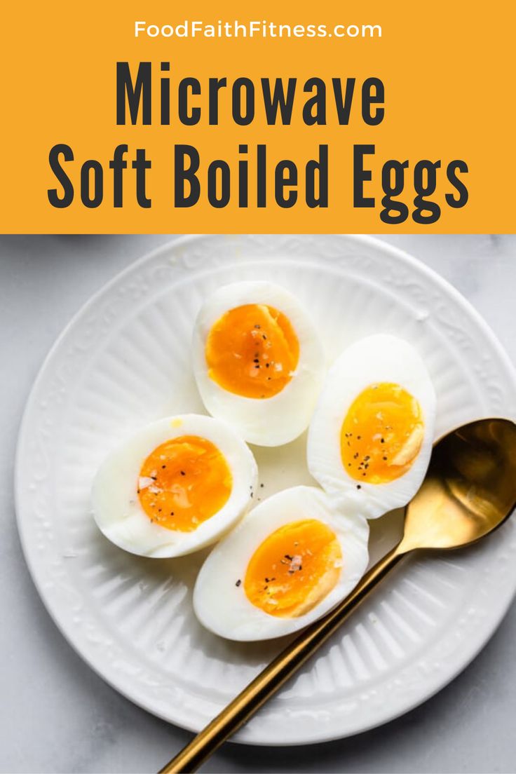 three hard boiled eggs on a white plate with gold spoons and text overlay that reads microwave soft boiled eggs