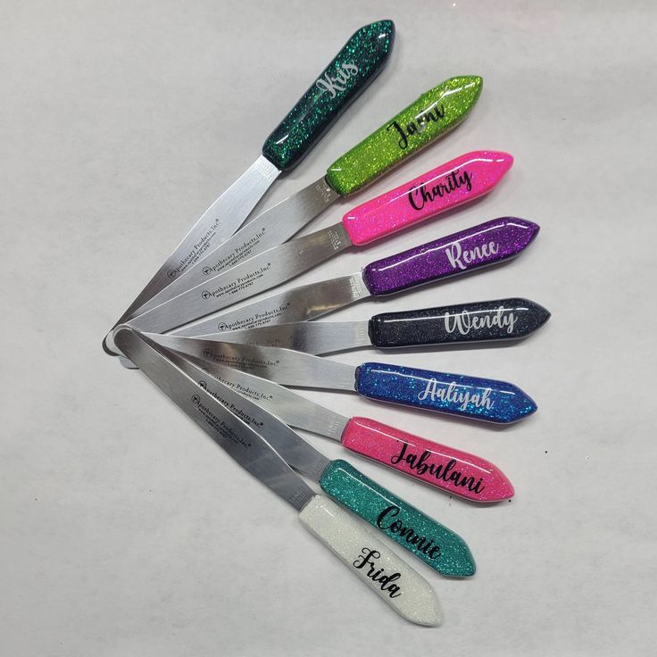 a set of six personalized knives with glittered handles are shown in the shape of a heart