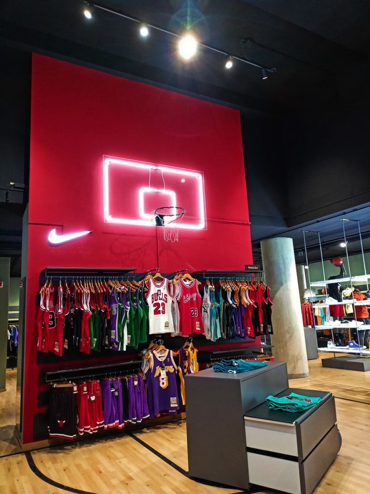 the inside of a nike store with clothes on display