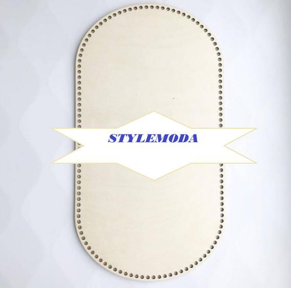 the word stylemoda is written in blue ink on a white leather oval with stitching