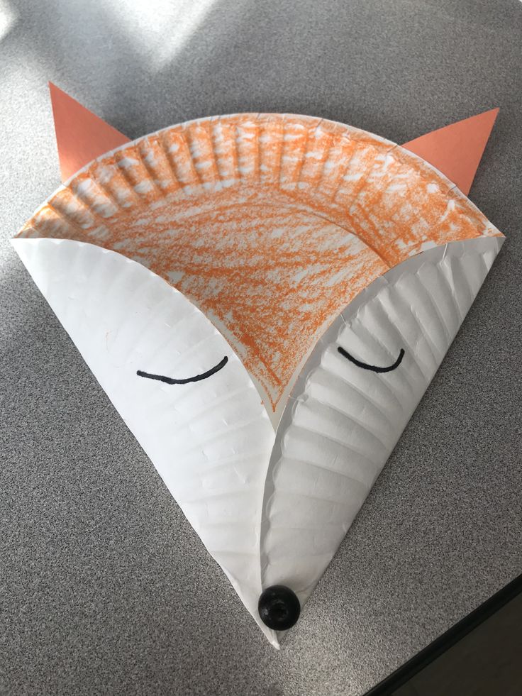 an orange and white paper plate shaped like a fox