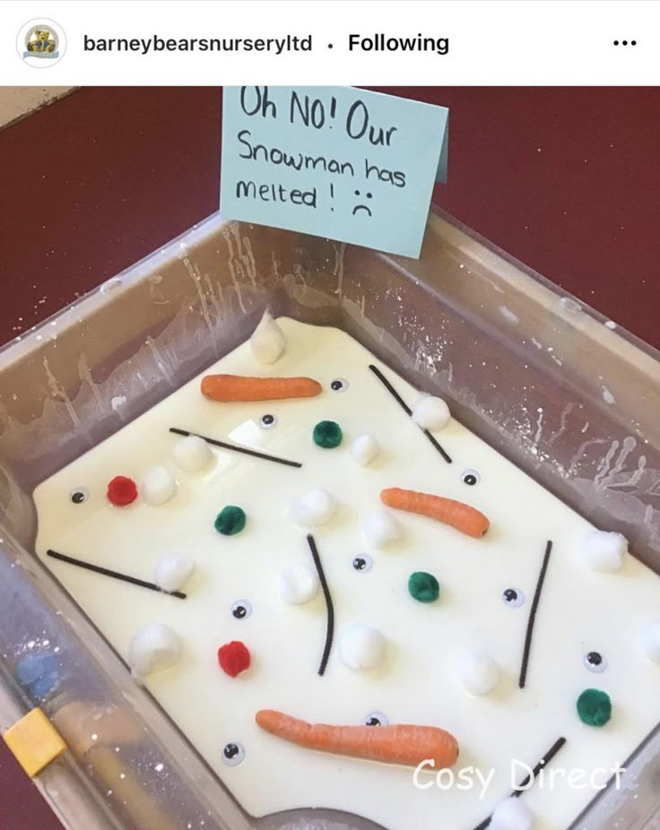 a plastic container filled with frosting and carrots next to a sign that says, oh not our snowman ice melted 1 / 4's