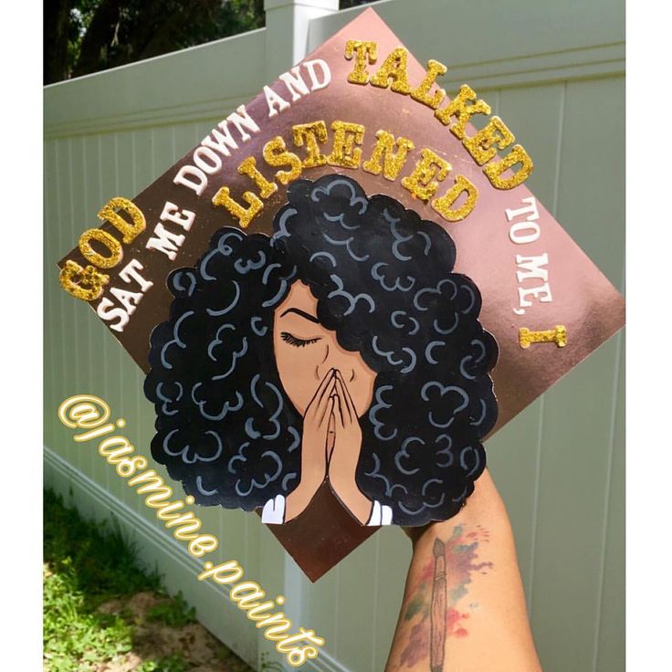 a person holding up a graduation cap with the words god, down and ahead on it