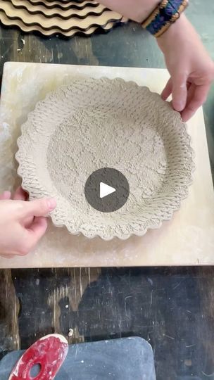 someone is making a bowl out of clay