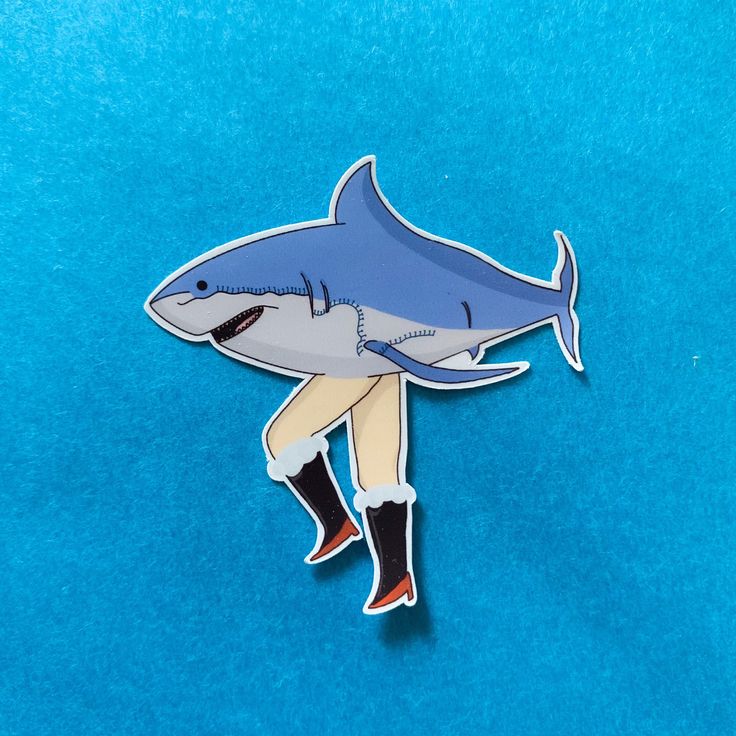 a blue and white shark sticker sitting on top of a blue surface