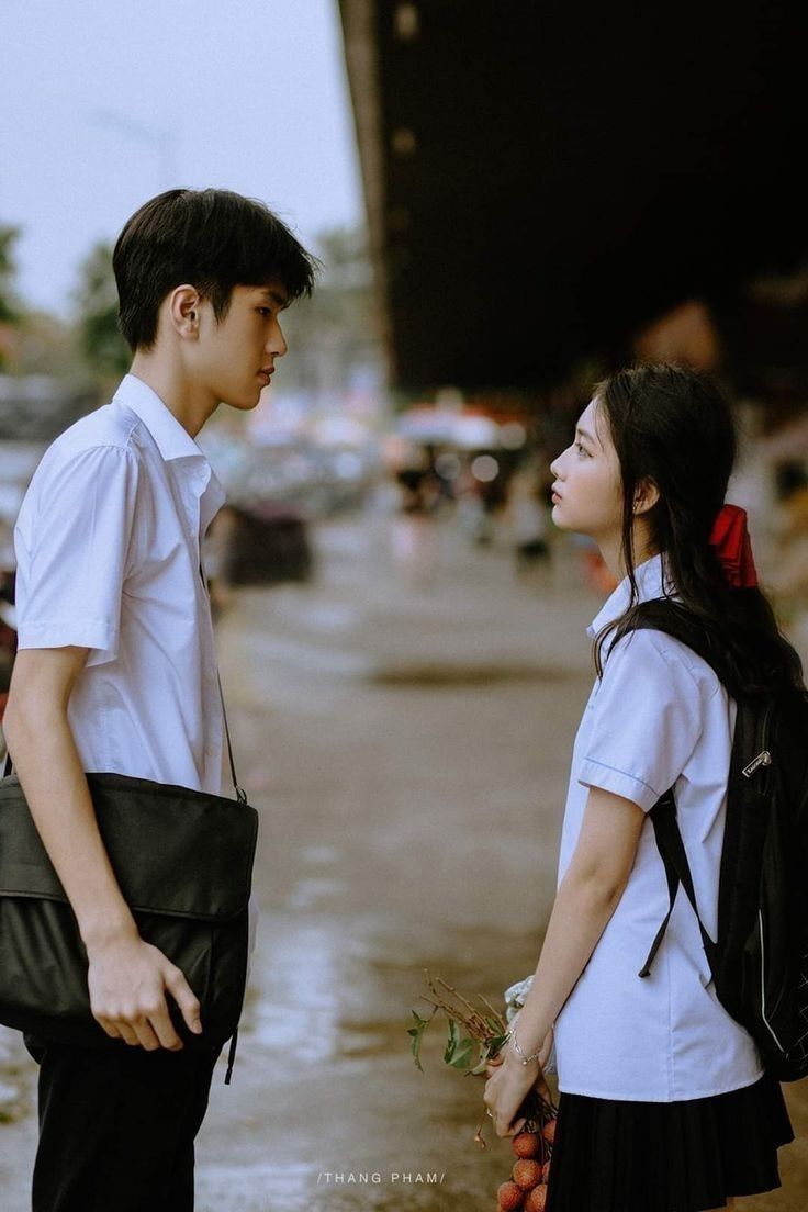 a young man and woman standing next to each other