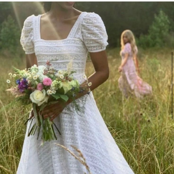 a woman in a white dress holding a bouquet