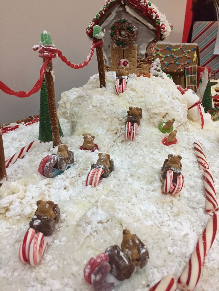 a large cake covered in white frosting and candy canes on top of a table